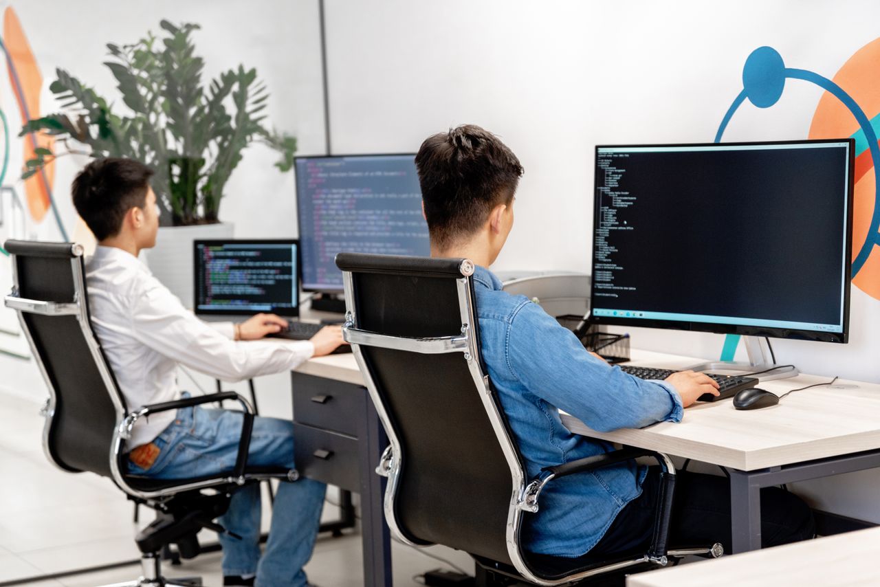 Developers working with code on desktop computers