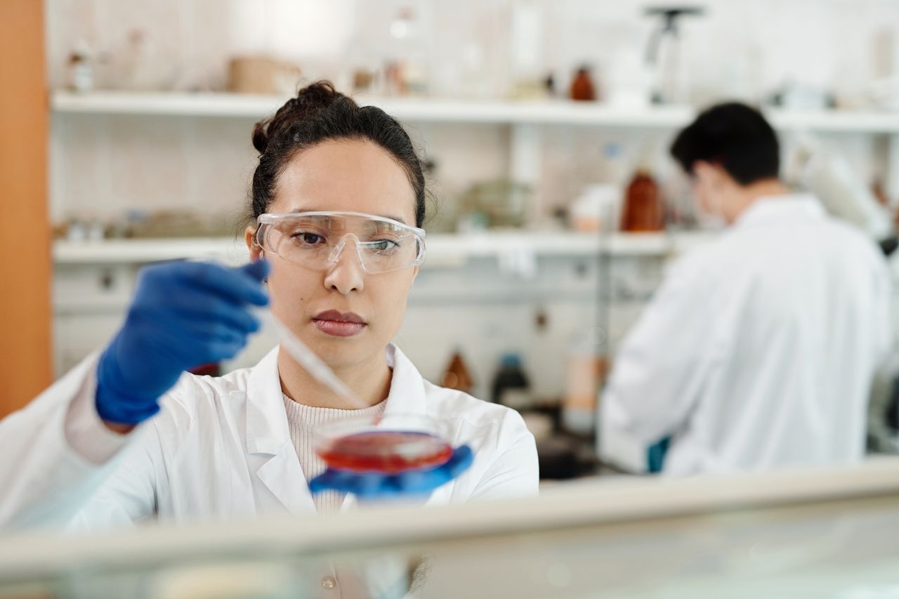 A scientist working with a pipette and research samples