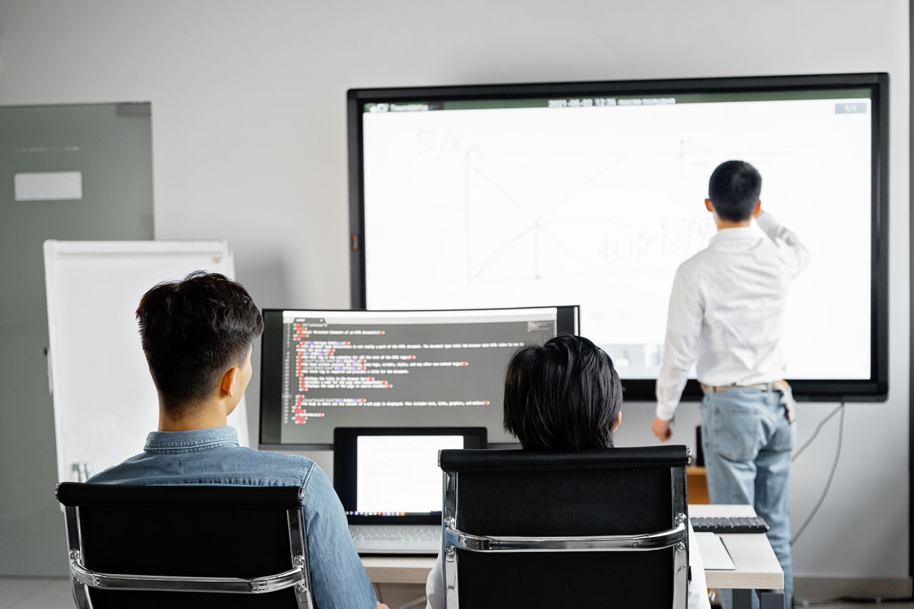 A presenter explaining a business workflow to a group