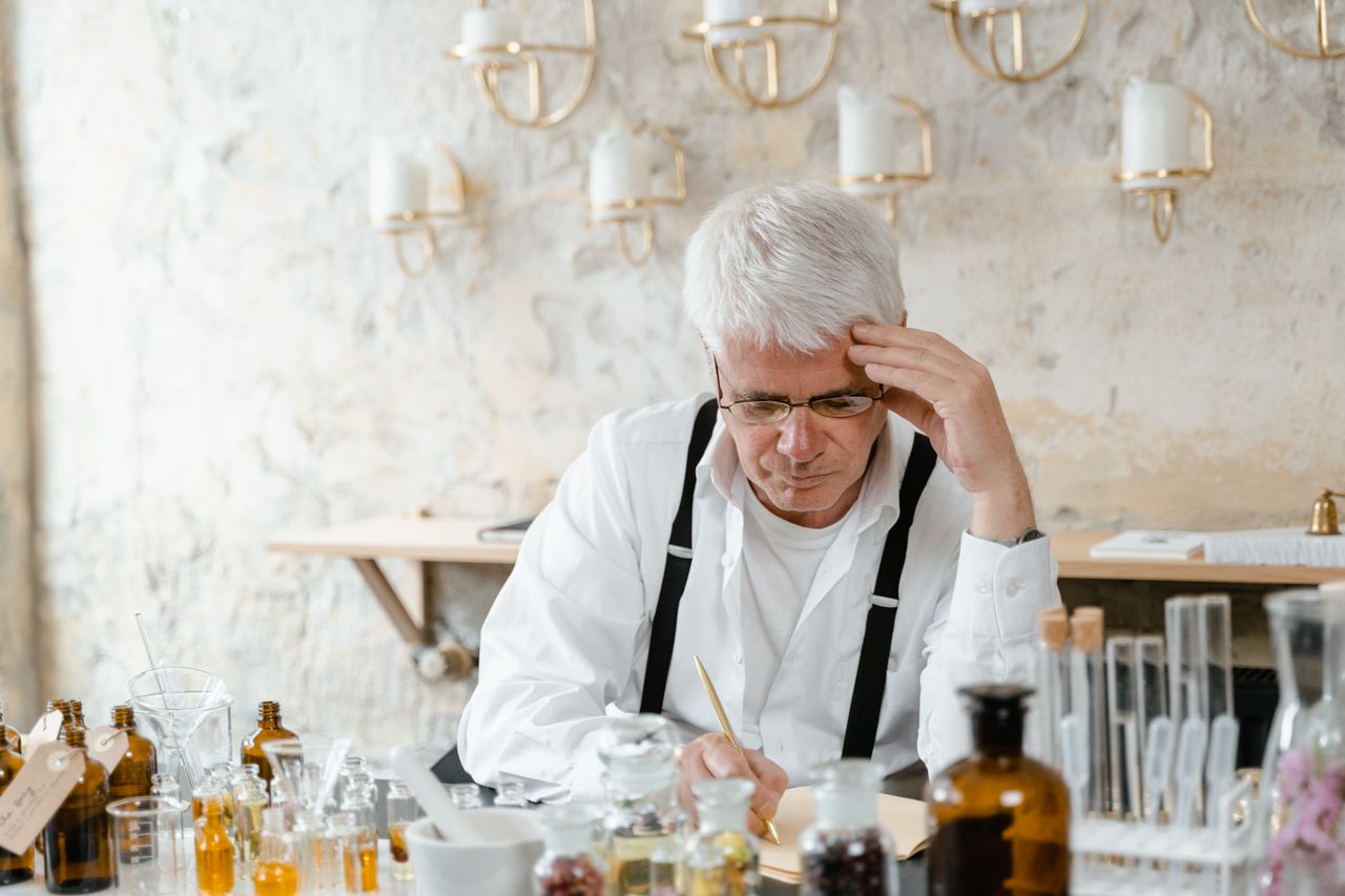 A researcher examining aroma samples and recording observations