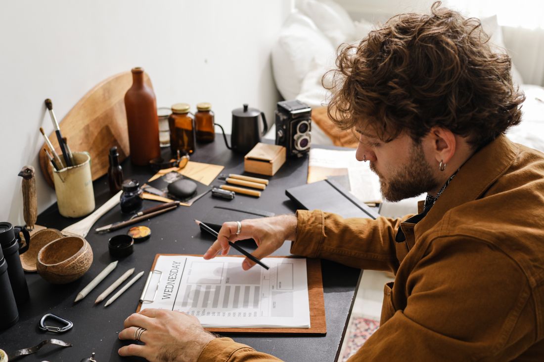 A professional making a plan in a notebook at his desk