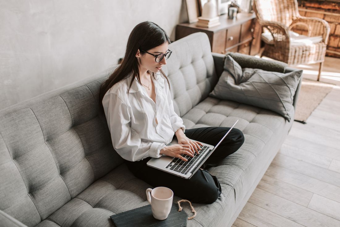 A woman working on a laptop from home